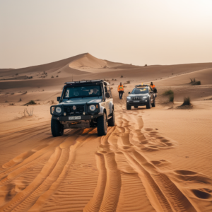 A stranded off-road vehicle stuck in the UAE desert as a rescue team in a 4x4 approaches to provide assistance.