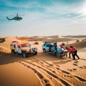 Off-road recovery truck rescuing a stranded vehicle in the Dubai desert, showcasing UAE desert recovery services